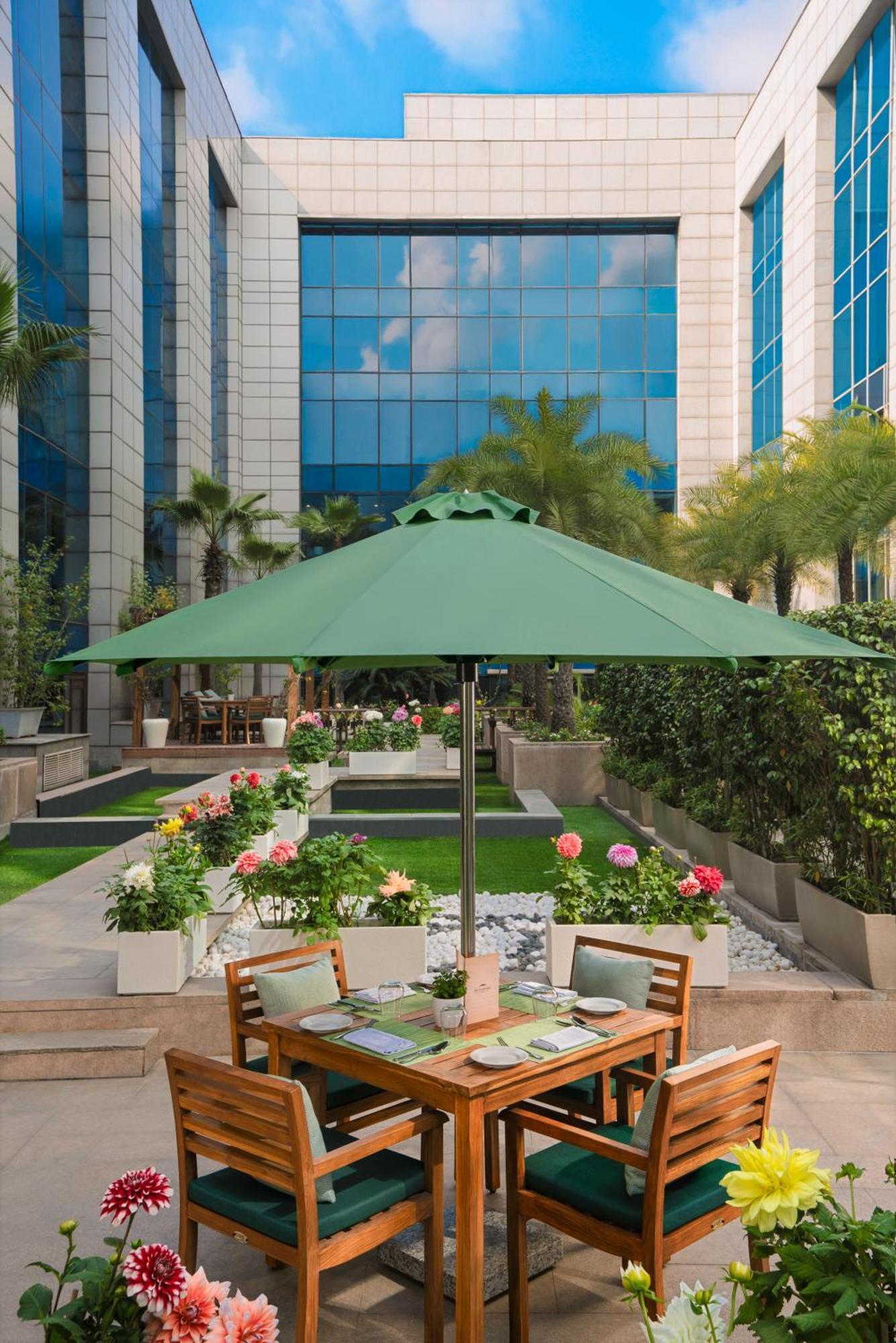 The Leela Ambience Gurugram Hotel & Residences - The Luxury Urban Sanctuary Гургаон Екстериор снимка A patio umbrella